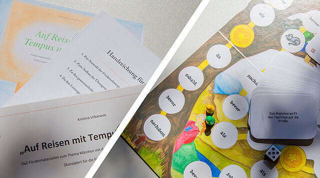 Arbeitsheft und Karton sowie bunter Spielplan und Kärtchen auf Tisch