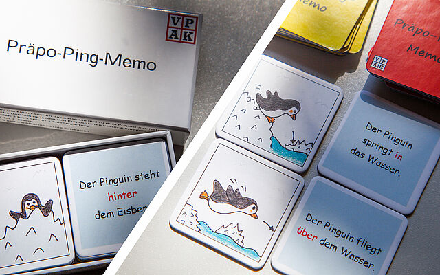 Pinguinspielkärtchen im Karton und ausgelegt auf Tisch